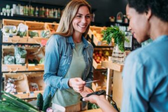 Customer-paying-bill-with-credit-card-at-organic-co-op-grocery-store_VioletaStoimenova.jpg