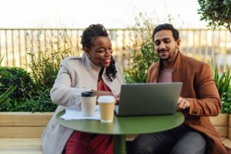 Two-people-at-rooftop-garden-looking-at-computer_Oscar-Wong.jpg