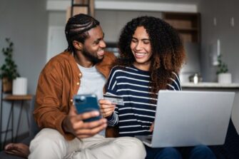 Young-couple-shopping-online-using-credit-card-and-laptop-at-home_FG-Trade.jpg