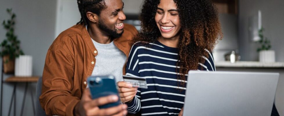 Young-couple-shopping-online-using-credit-card-and-laptop-at-home_FG-Trade.jpg